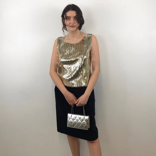 1960s Gold and Silver Sleeveless Sequin Top Size Medium - Large paired with Yves Saint Laurent black velvet skirt and 60s quilted silver evening bag sold by bohemevintage.com Montreal