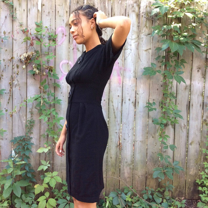 Side view of 1960s Short Sleeve Black Wool Dress Size Small sold by bohemevintage.com Montreal