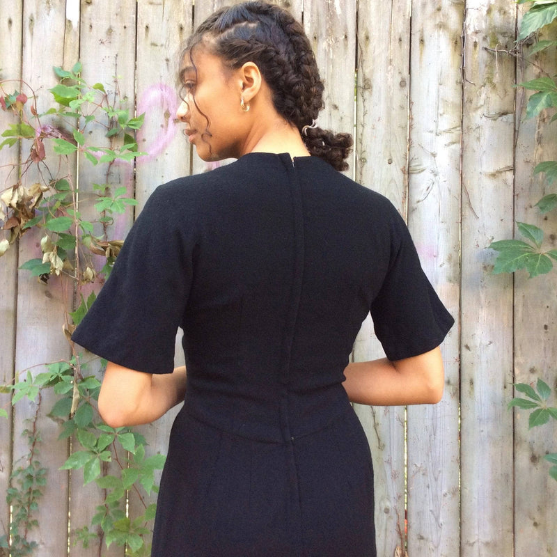 Back view of 1960s Short Sleeve Black Wool Dress Size Small sold by bohemevintage.com Montreal