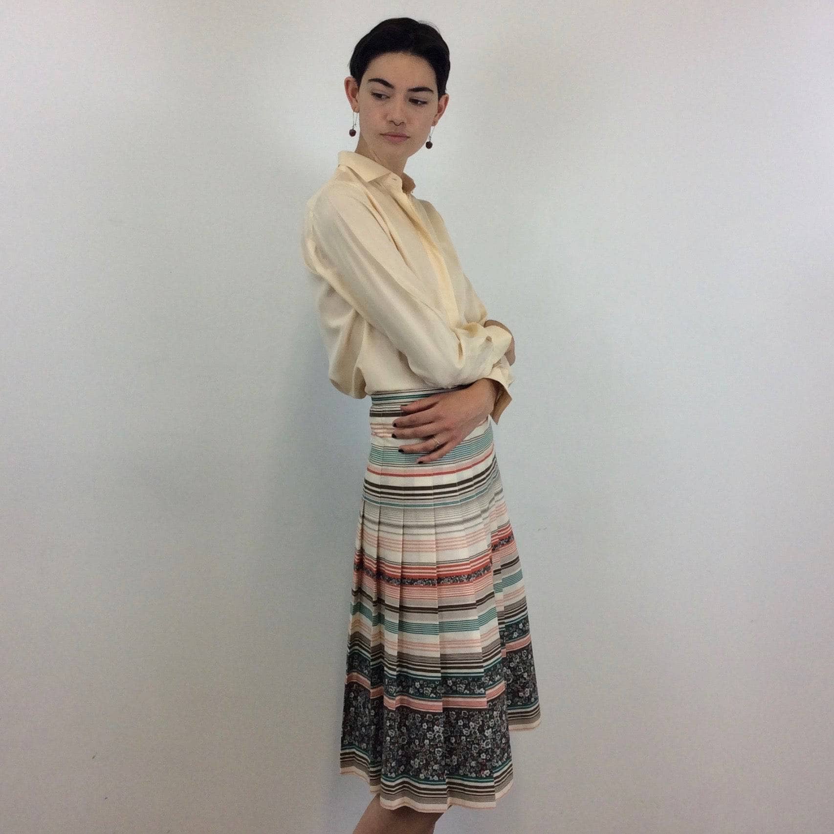 Side view of Mister Leonard 1970s Bold Print Pleated Cotton Midi Skirt Size Small sold by bohemevintage.com