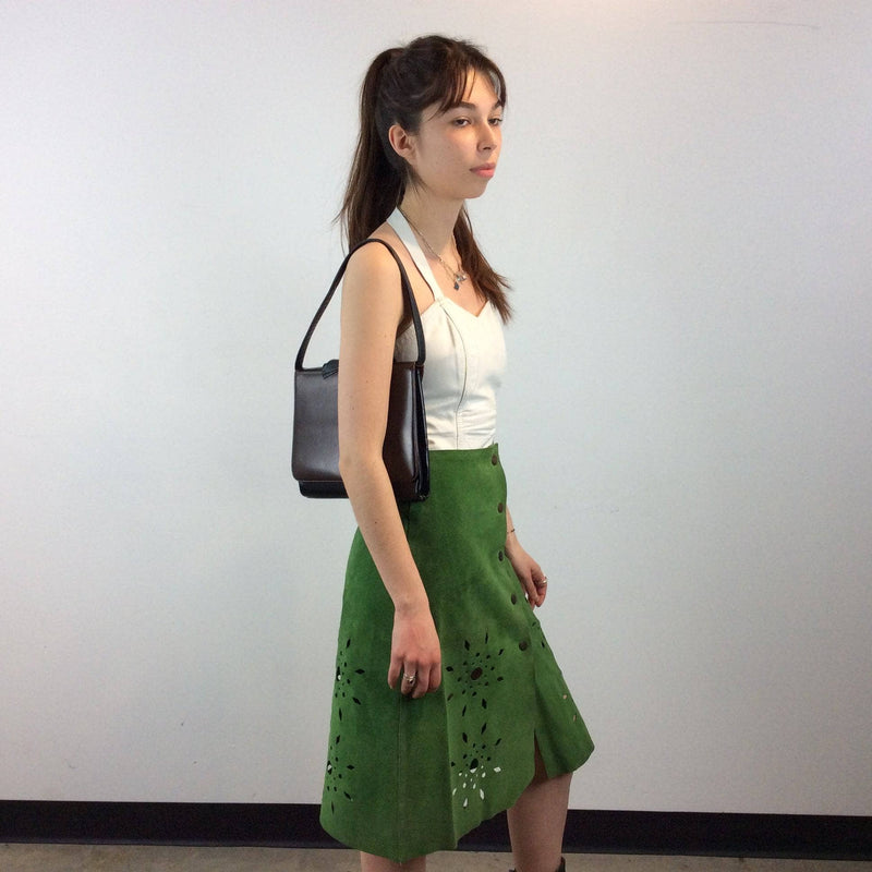 Side view of 1970s Cut Out Green Suede Skirt sold by bohemevintage.com Montréal