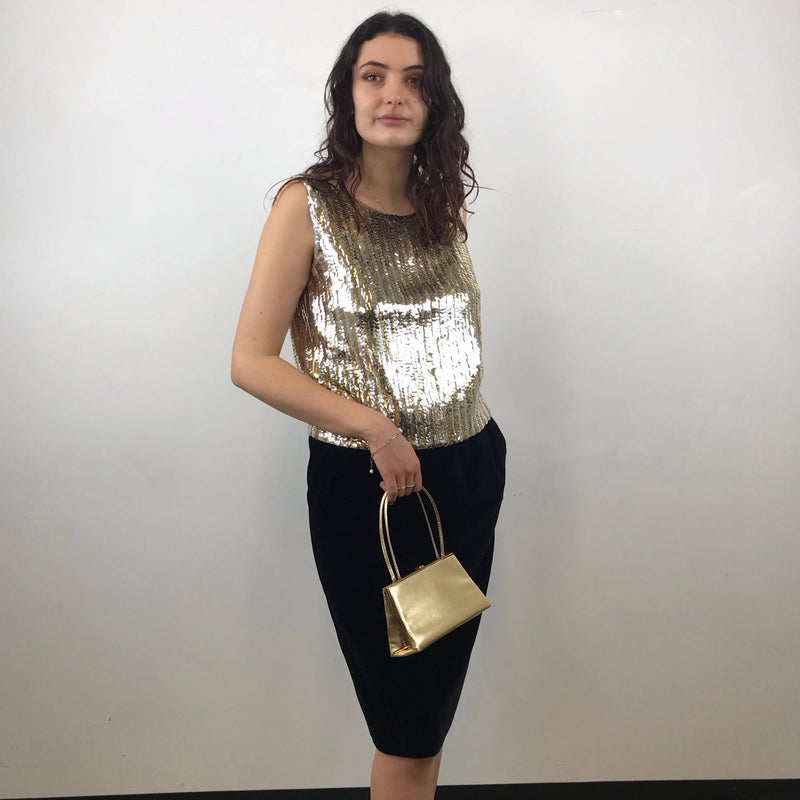 1970s Yves Saint Laurent Rive Gauche Black Velvet Skirt Size Medium paired with a 1960s gold and silver sequin top and 60s gold handbag are sold by bohemevintage.com Montreal