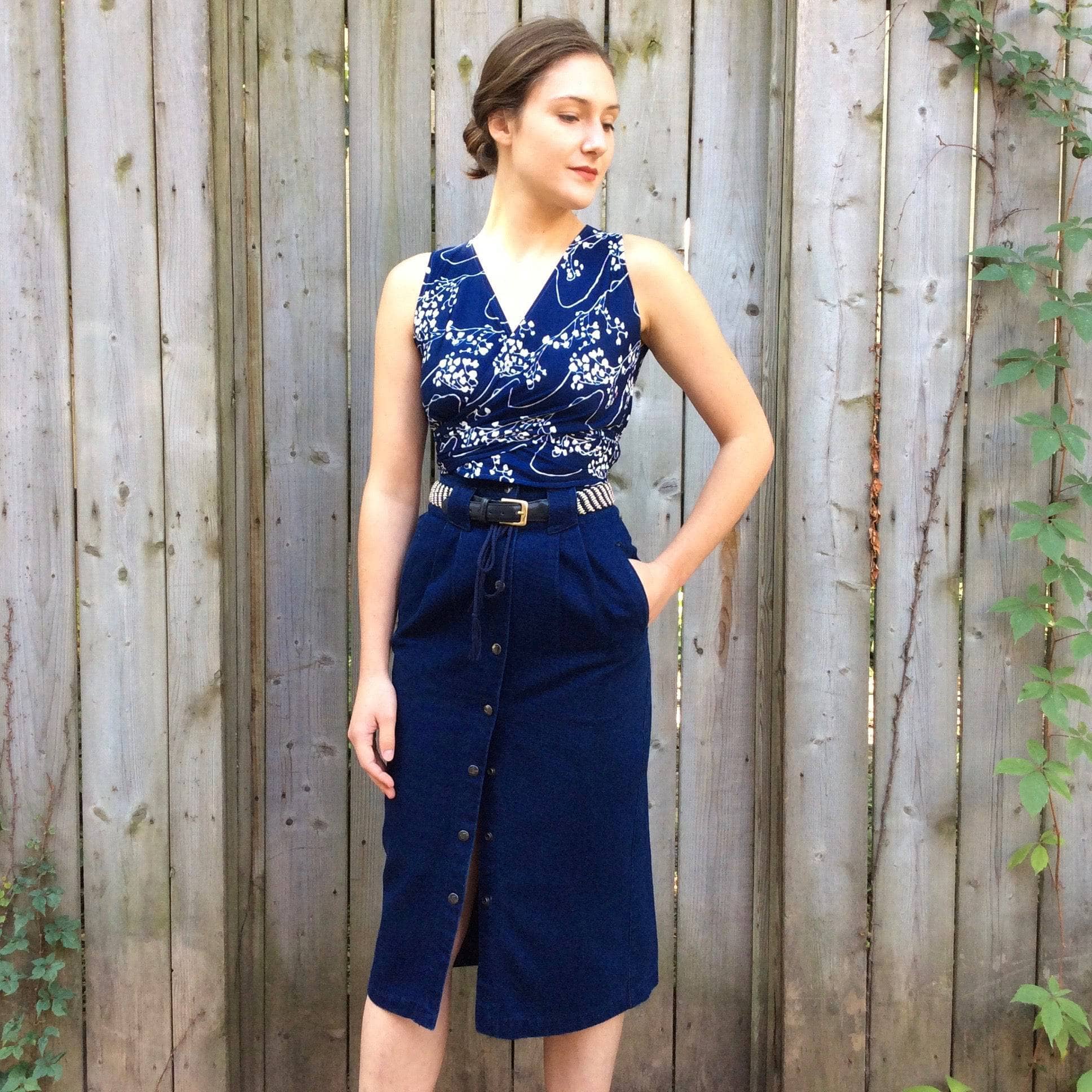 Front view of 1980-90s High-Waisted Midi length Dark wash Denim Skirt Size Small sold at bohemevintage.com Montreal  