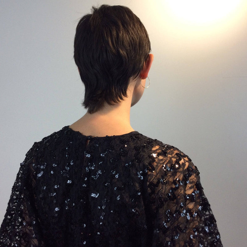 Close-up view of back of 1980s Batwing Sleeve Lace and Sequin Black Top Size small-Medium sold by bohemevintage.com MontrealBack 