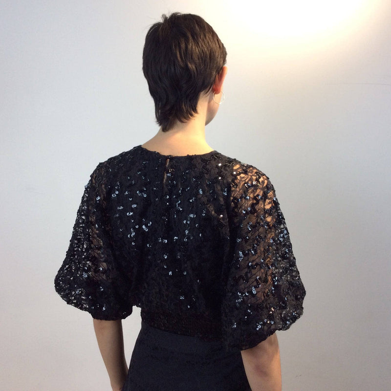 Back view 1980s Batwing Sleeve Lace and Sequin Black Top Size small-Medium sold by bohemevintage.com Montreal