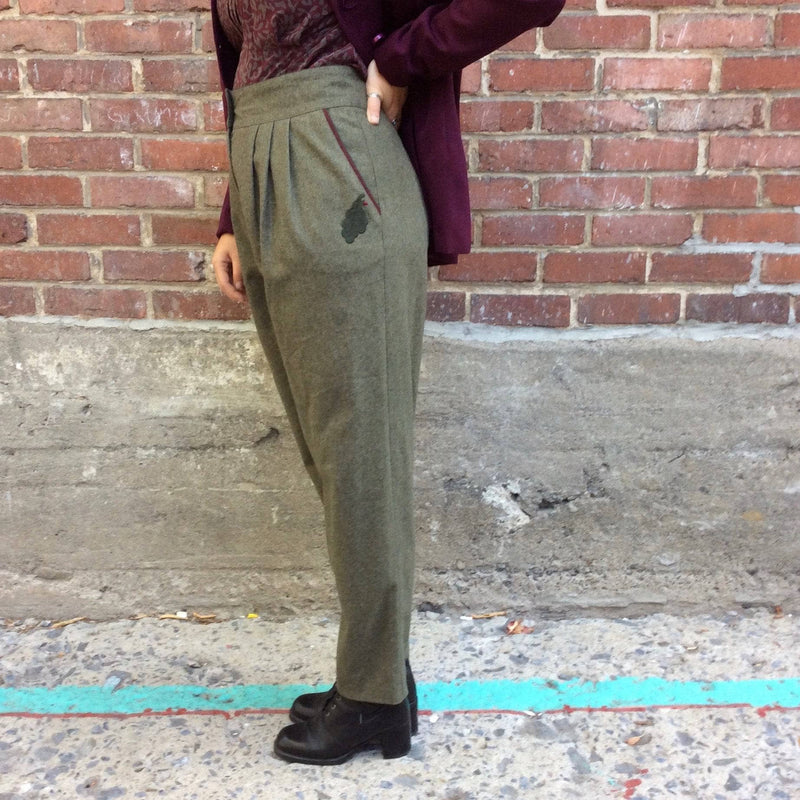Side view of 1980s High-Waist Tapered Leg Army Green Wool Pleated Pants, for sale at bohemevintage.com Montréal
