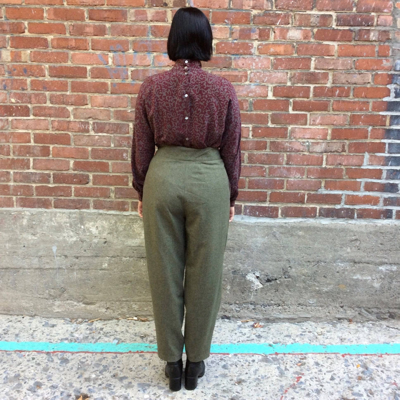 Back view of 1980s High-Waist Tapered Leg Army Green Wool Pleated Pants, for sale at bohemevintage.com Montréal