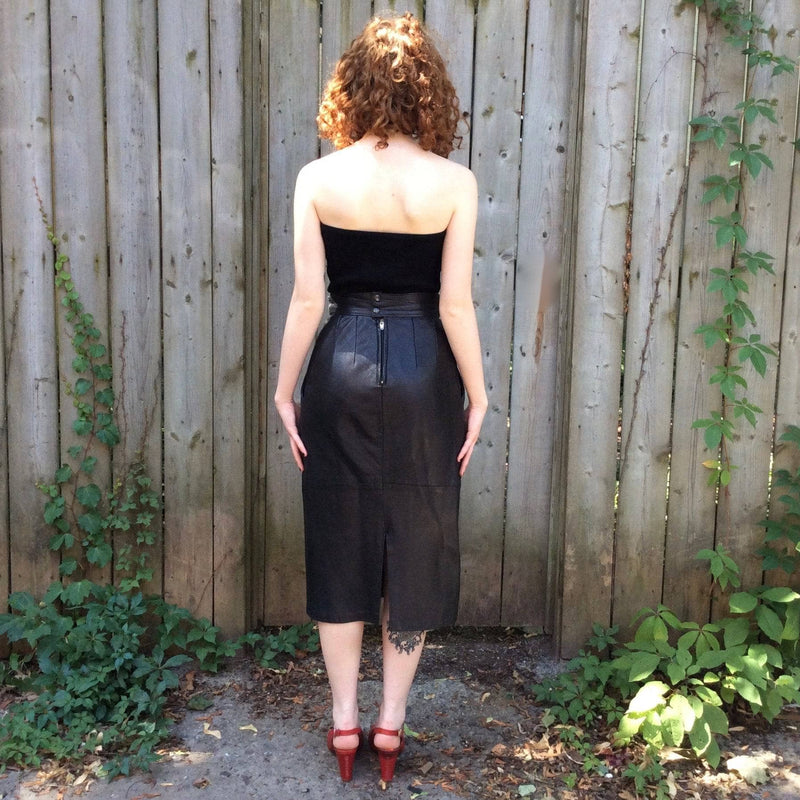 Back view  of 1980s High-Waisted Midi Length Leather Skirt from Pegabo Size small sold by bohemevintage.com Montreal 