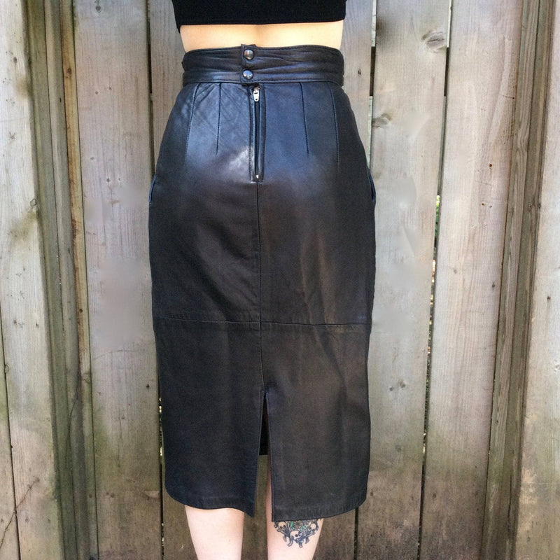 Back view of 1980s High-Waisted Midi Length Leather Skirt from Pegabo Size small sold by bohemevintage.com Montreal