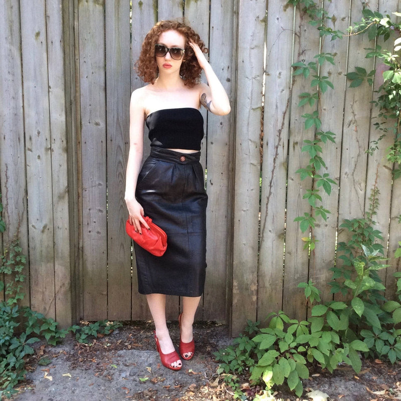 1980s High-Waisted Midi Length Leather Skirt from Pegabo Size small with red leather clutch sold by bohemevintage.com Montreal