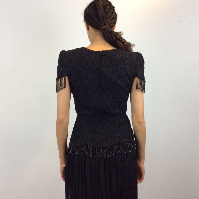 Back view of 1980s Black Short sleeve lace with beaded fringes Midi Dress Size Medium sold by bohemevintage.com Montreal