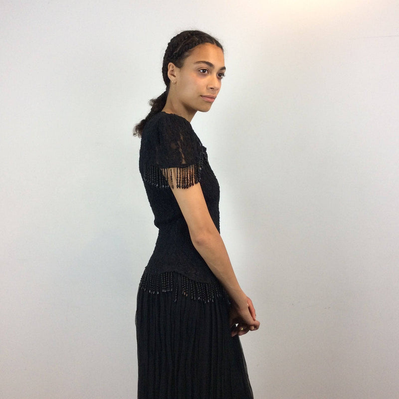 Side view of 1980s Black Short sleeve lace with beaded fringes Midi Dress Size Medium sold by bohemevintage.com Montreal