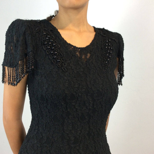 Close-up view of bodice of 1980s Black Short sleeve lace with beaded fringes Midi Dress Size Medium sold by bohemevintage.com Montreal