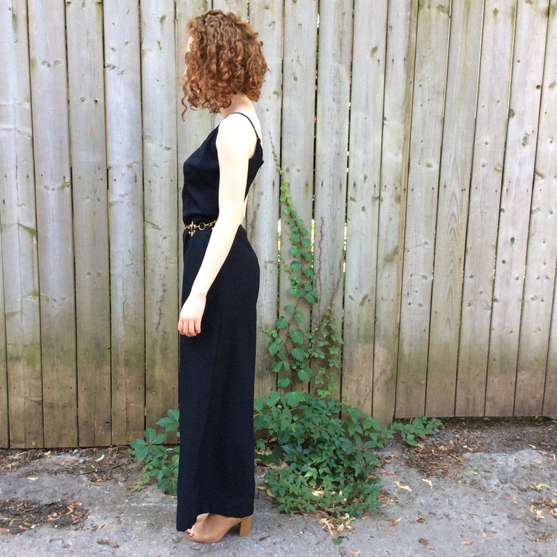 Side View of Sleeveless black jumpsuit sold at bohemevintage.com Montreal