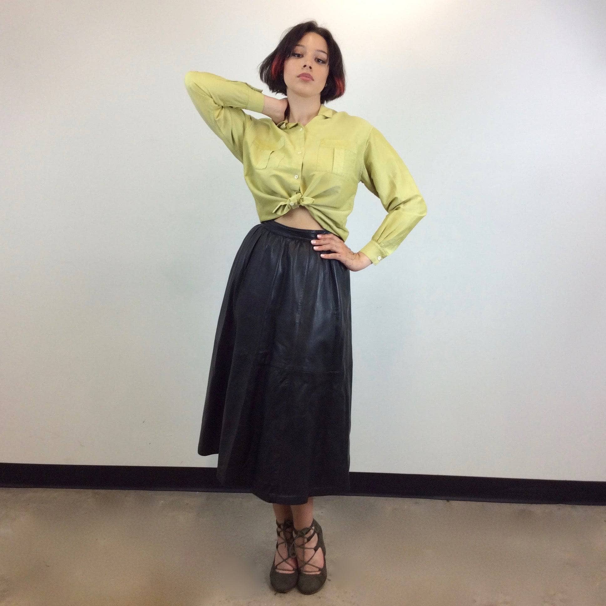 1990s Burberrys Raw Silk Blouse tied at the waist Size Medium worn with a midi length A-line leather skirt sold by bohemevintage.com Montreal