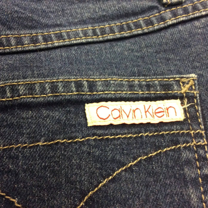 Close-Up of back pocket Tag of 1990s Calvin Klein Medium Rise Denim Mini Skirt, Size Small, sold by bohemevintage.com Montreal