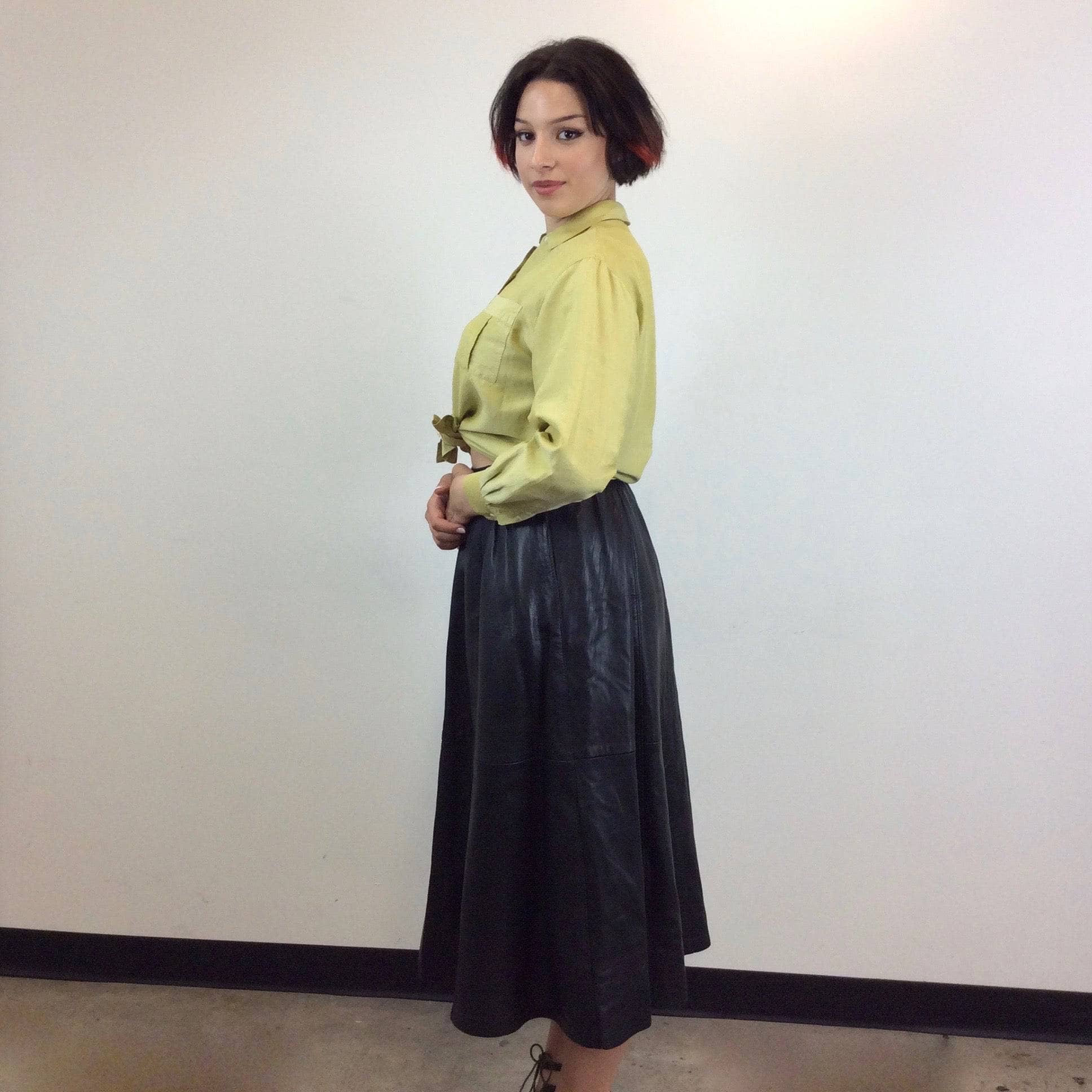 Side view of Flared Black Leather Midi Skirt Size Medium sold by bohemevintage.com