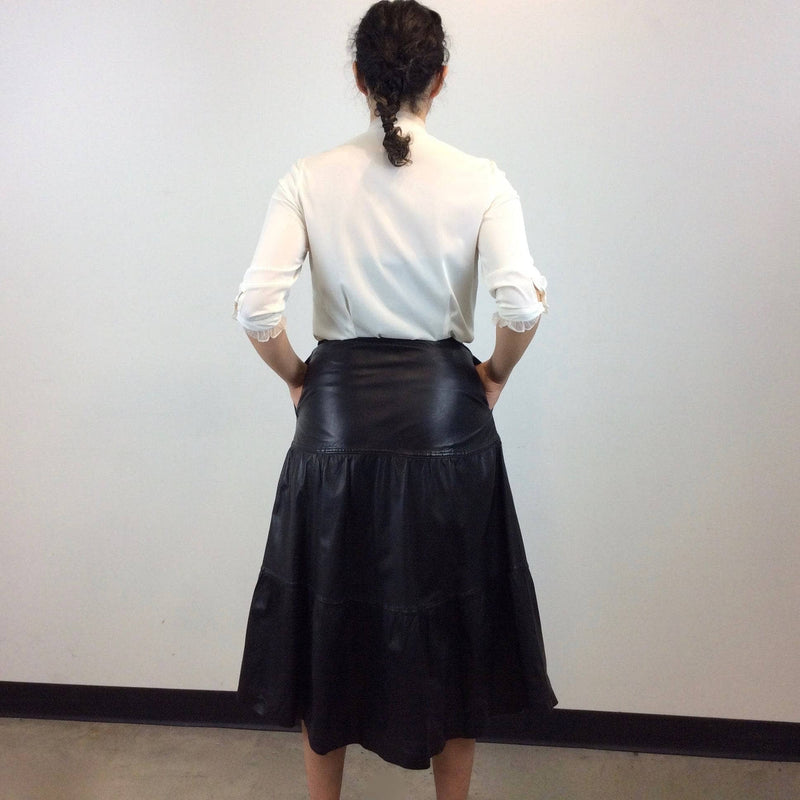 Back view of Leo Chevalier Tiered Black Leather Midi Skirt Size S/M sold by bohemevintage.com