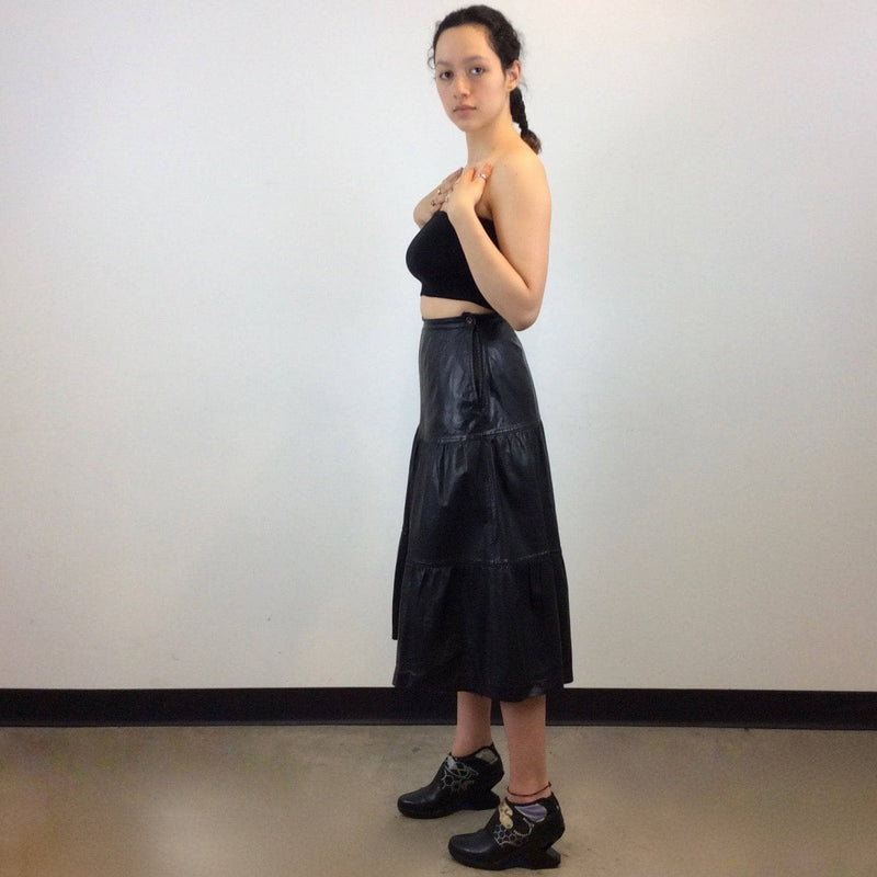 Side view of Leo Chevalier Tiered Black Leather Midi Skirt Size S/M sold by bohemevintage.com