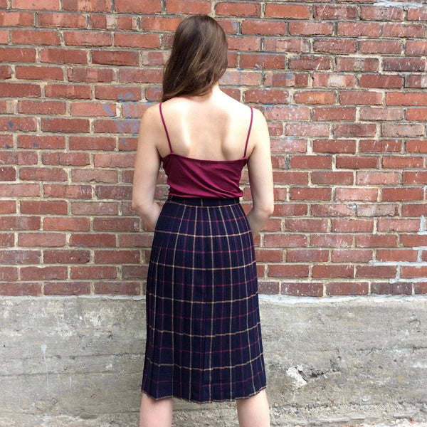 Back view of Midi-Length Pleated Tartan Wool Skirt Size S-M sold by bohemevintage.com